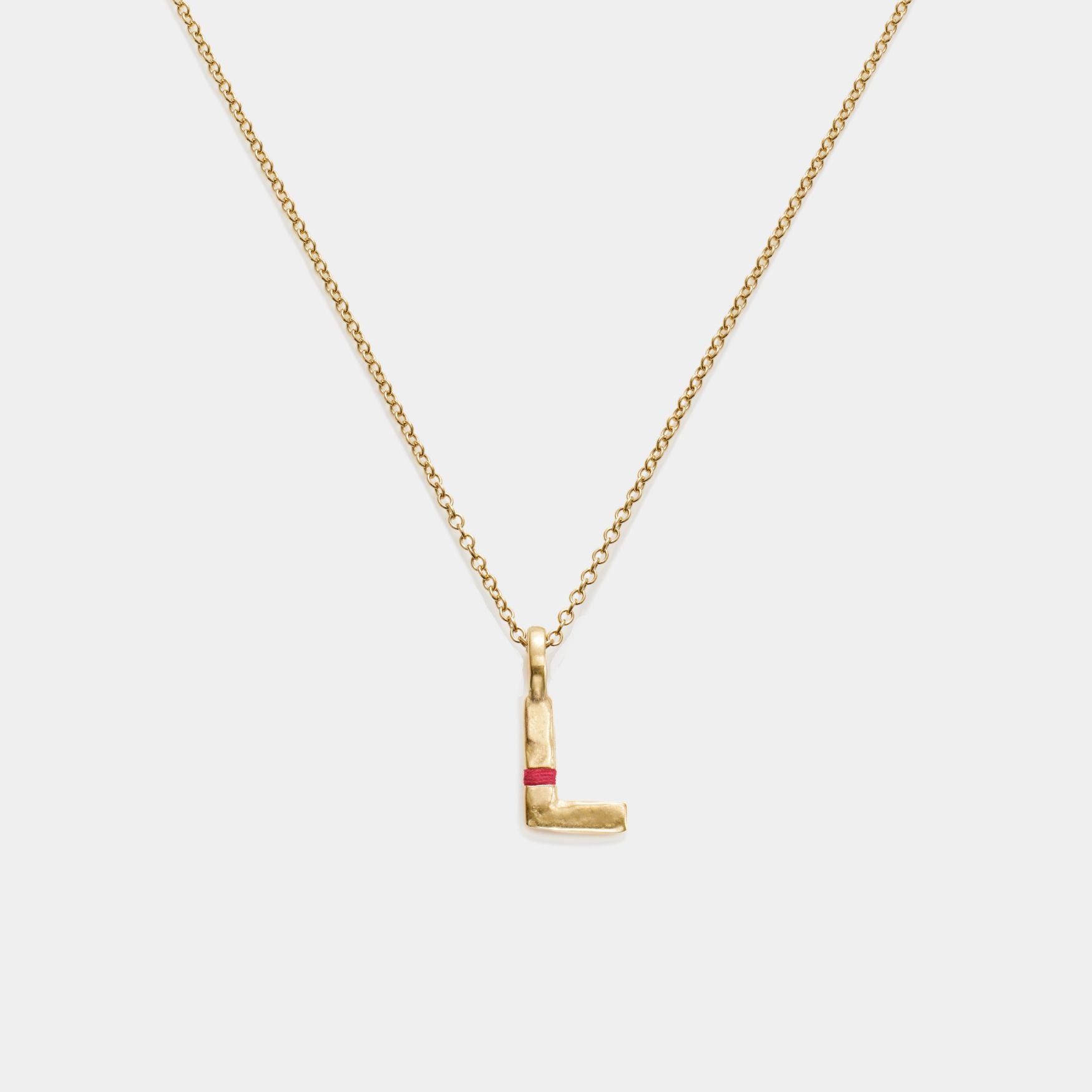Gold necklace with a letter 'L' pendant on a white background